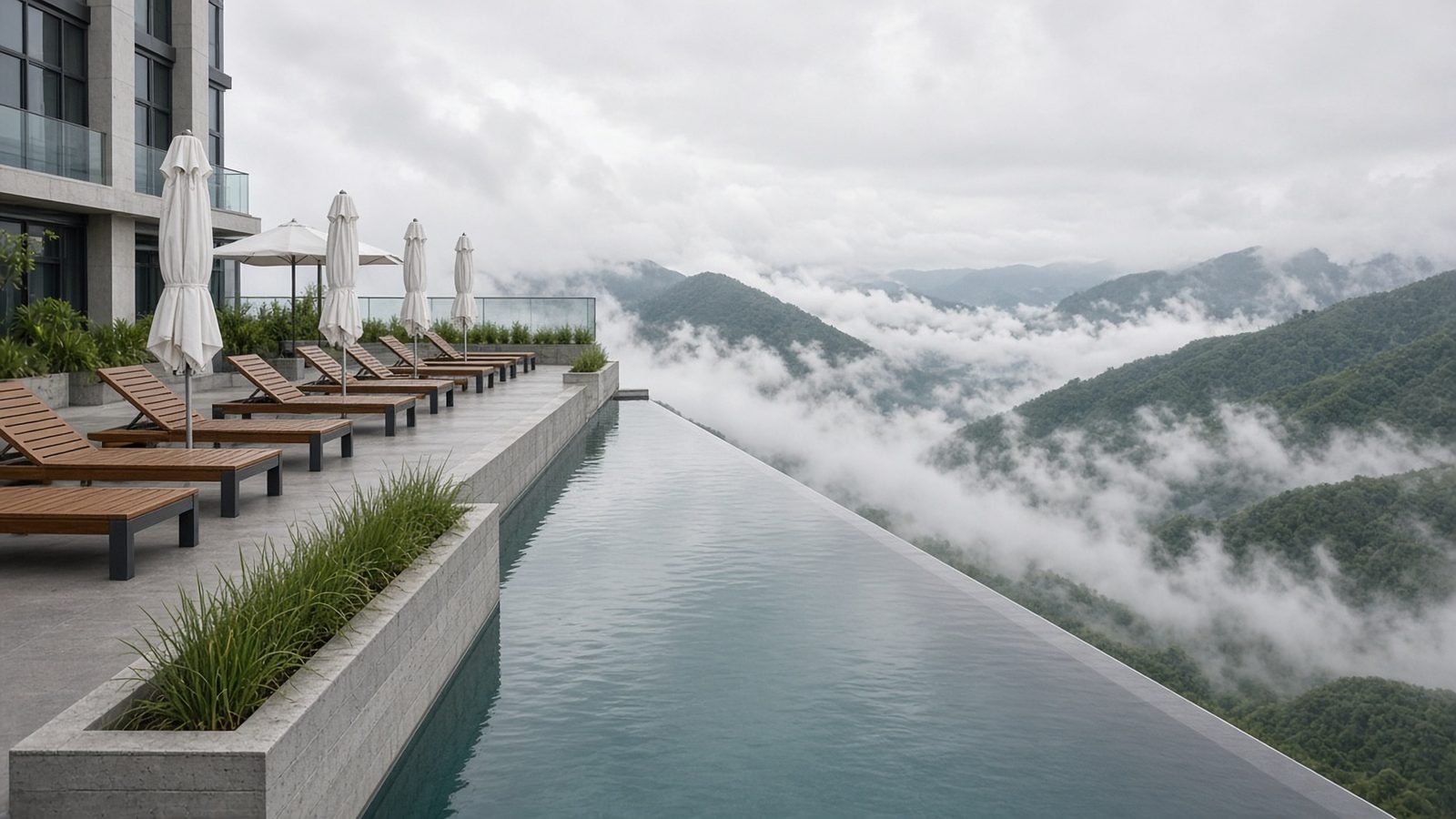 Infinity-edge rooftop pool with folded umbrellas and loungers, its edge meeting a valley of drifting cloud and green ridges (artist's impression)