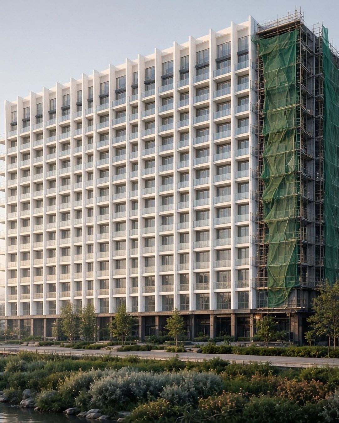 Meghvan Lakeside: a 14-floor building beside a misty lake, one wing finished and one still under scaffolding (artist's impression)